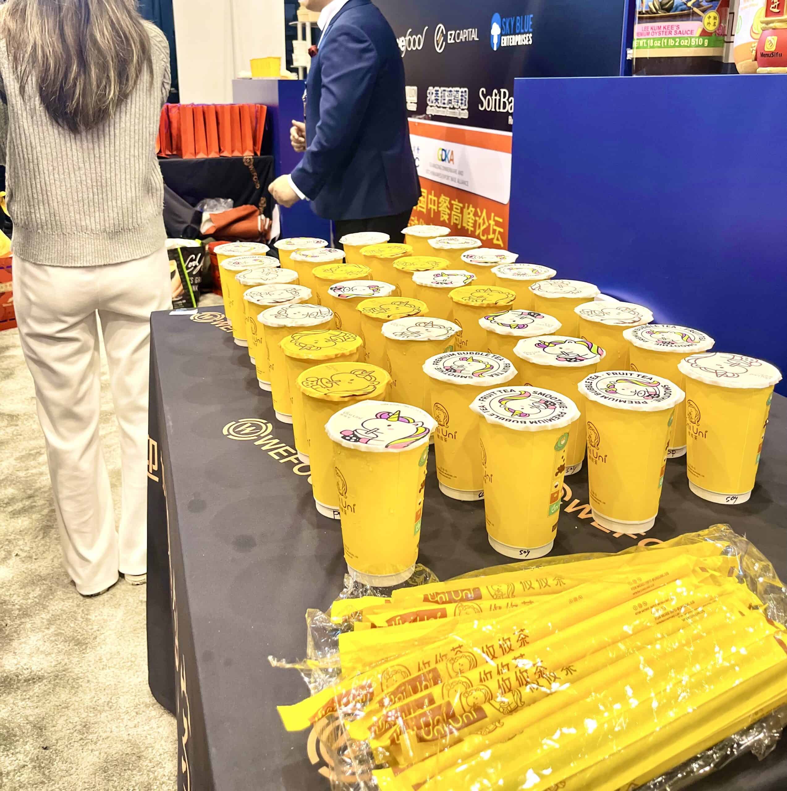 Colorful cups and yellow utensils displayed