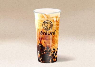 Close-up of Uni Uni Boba drink with tapioca pearls and creamy topping.