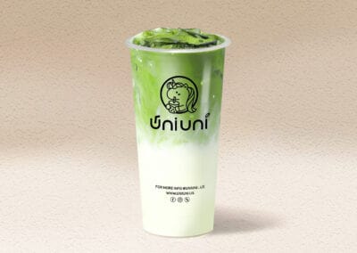 Fresh green tea boba drink with tapioca pearls in a clear cup.